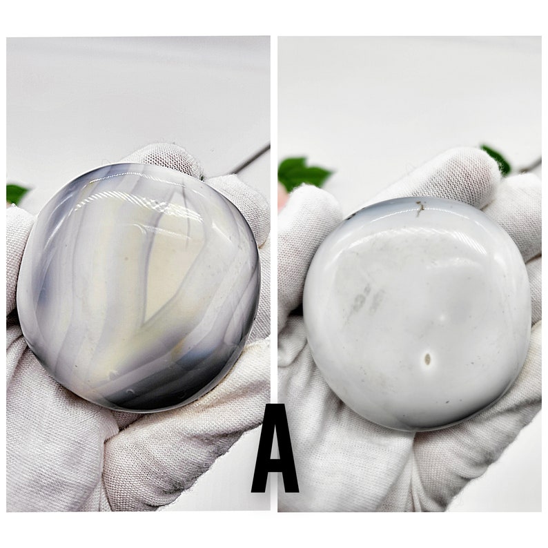 May include: Two agate stones, one with a white and gray swirling pattern and the other a solid white, both polished smooth.
