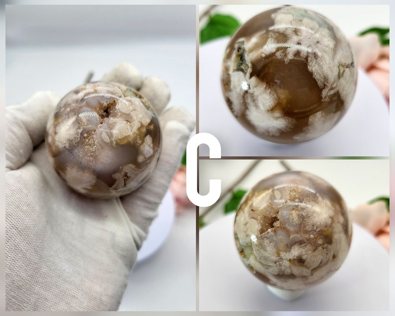 May include: A white and brown agate sphere with a cloudy pattern. The sphere is smooth and polished.