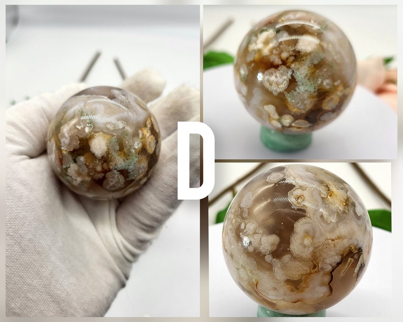 May include: A white, brown, and green agate sphere with a swirling pattern. The sphere is polished and smooth.