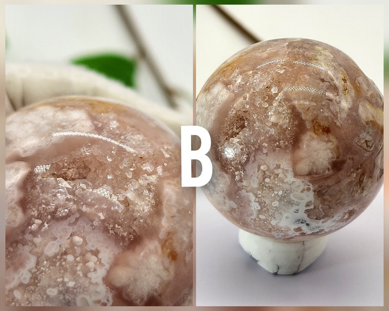 May include: A close-up of a pink and white agate sphere with a white base. The sphere has a unique pattern of white and brown markings.