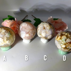 May include: Four agate spheres with different patterns and colours, labelled A, B, C, and D. The spheres are white, pink, and brown with white and green patterns.