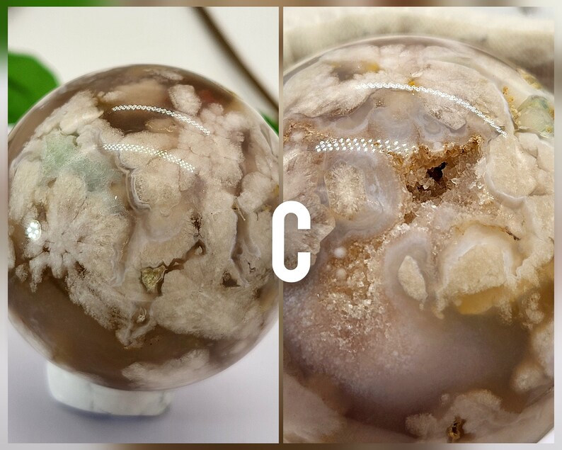 May include: A white and brown agate sphere with a unique, cloudy pattern. The sphere is polished and smooth, with a translucent appearance. The sphere is approximately 5 cm in diameter.