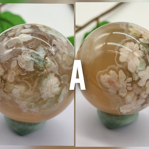 May include: Two agate spheres with a light brown base and white and green floral patterns. The spheres are on green stands. The spheres are labelled "A".