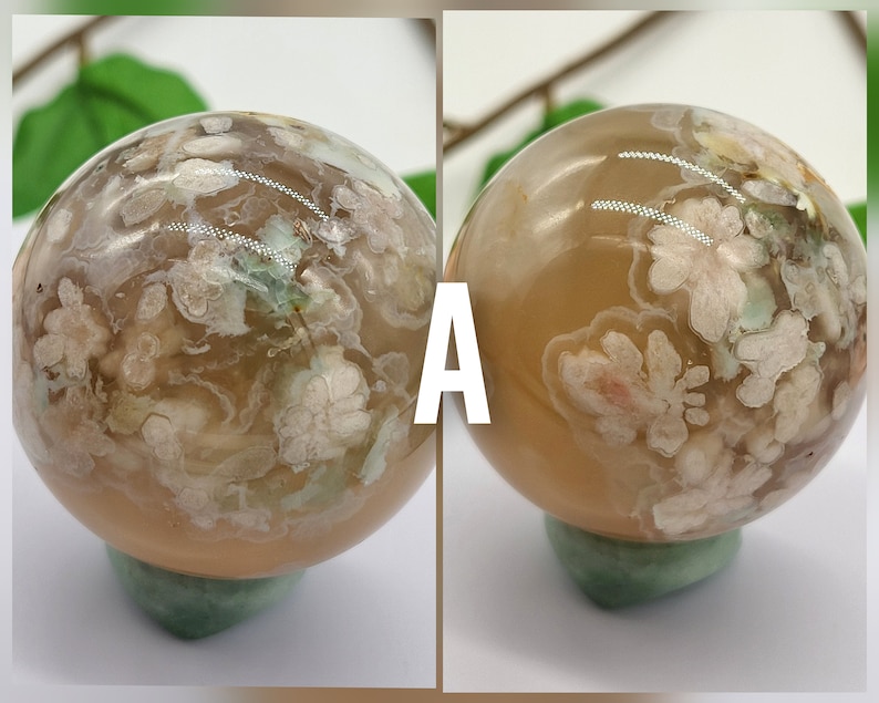 May include: Two agate spheres with a light brown base and white and green floral patterns. The spheres are on green stands. The spheres are labelled "A".