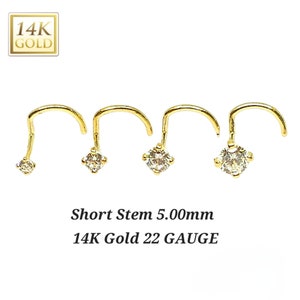 May include: Three gold nose rings with a small clear gemstone on the end. The rings are 22 gauge and have a short 5.00mm stem. 14K Gold.