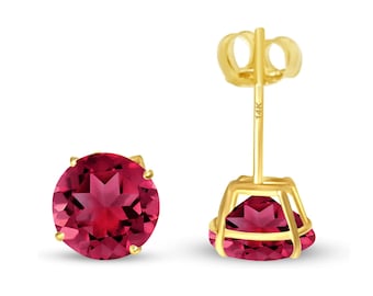 May include: A pair of 14k gold stud earrings featuring round red gemstones. The earrings have a simple design and are ideal for everyday wear.