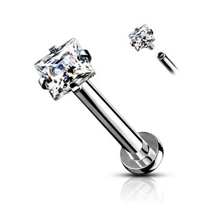 May include: A silver barbell with a clear square-shaped gem on the end. The barbell is designed for a body piercing.
