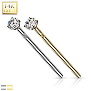 May include: Two nose rings with a clear gemstone. One ring is made of 14k gold and the other is made of silver.