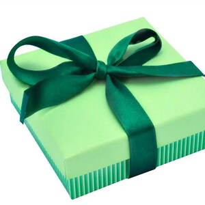 May include: A green gift box with a green satin ribbon tied in a bow.