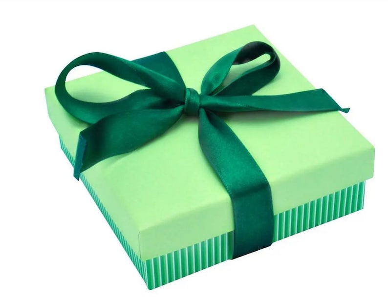 May include: A green gift box with a green satin ribbon tied in a bow.