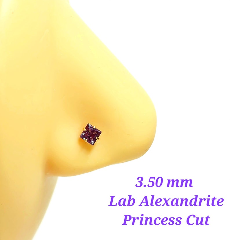 May include: A purple lab-created alexandrite gemstone nose stud with a princess cut. The stud is 3.50 mm in size and is set in gold.