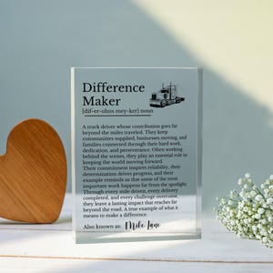 May include: A clear rectangular acrylic plaque featuring black printed text that defines the term Difference Maker as a truck driver. The design includes a graphic of a semi-truck and the name Mike Lane at the bottom, honoring their hard work.