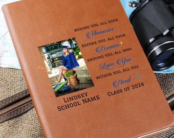 May include: A brown leather journal with a graduation quote and a photo of a graduate in a blue cap and gown. The quote reads "Behind you, all your memories. Before you, all your dreams. Around you, all who love you. Within you, all you need. Lindsey School Name Class of 2024".