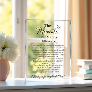 May include: A clear rectangular acrylic plaque featuring black printed text that reads: The Moments That Make A Difference, followed by a paragraph about kindness and the closing phrase, Thank you for everything Mary!