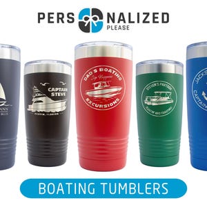 May include: Five stainless steel tumblers with different designs and text. The tumblers are all the same size and shape. The designs include a sailboat, a boat, an anchor, and a boat with the text "Dad's Boating Excursions".