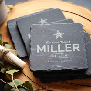 May include: Set of four black slate coasters with a white starfish design and the text "Mike and Hannah MILLER EST. 2016 SAN DIEGO, CALIFORNIA".