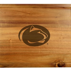 May include: A wooden cutting board with a brown engraved logo of a lion's head in an oval. The logo is centered on the board.