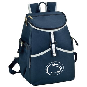 May include: A navy blue insulated backpack with a white Penn State Nittany Lions logo. The backpack has a white zipper and white trim around the top and bottom. It has a white strap with a buckle and two side pockets.