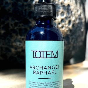 May include: A dark blue glass dropper bottle with a black cap and a light blue label. The label features the text TOTEM, ARCHANGEL RAPHAEL, and a description of the flower essence blend including Queen Anne's Lace, Nasturtium, and Fig Tree.