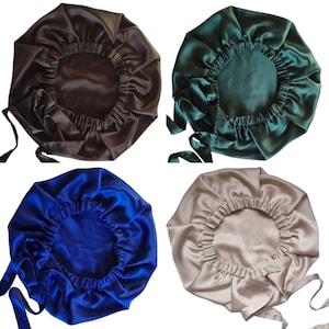 May include: Four satin bonnets in different colors: brown, dark green, blue, and taupe. Each bonnet has an elastic band and long ties for securing. The bonnets are designed to protect hair and maintain hairstyles.