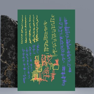 May include: A green rectangular artwork with colorful scribbled text and abstract shapes. The text is in yellow, orange, and blue. The artwork is propped up by two black marble blocks.