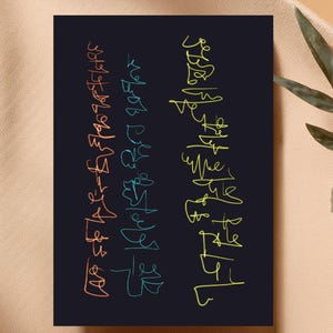 May include: A dark navy blue art print featuring abstract line art in orange, teal, and yellow. The artwork has a minimalist style with flowing, handwritten-like lines arranged vertically on the print.