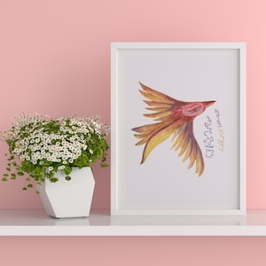 May include: A framed print featuring a stylised bird illustration in shades of orange, yellow, and red with closed eyes. The artwork includes vertical script text in black and gold ink. The frame is white and rectangular with a clean, simple border.