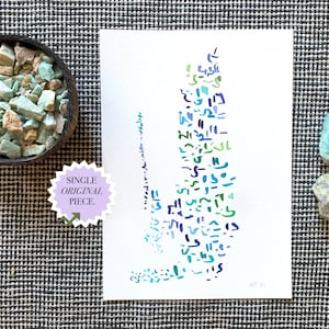 May include: An abstract watercolor painting with blue, green, and purple brushstrokes. A small bowl of turquoise stones and two gemstones are next to the painting. The painting has the text "SINGLE ORIGINAL PIECE."