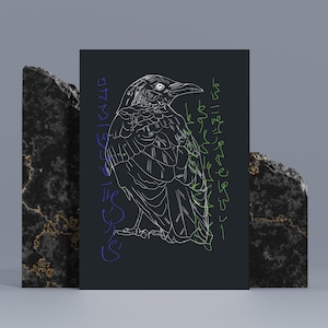 May include: A black art print featuring a detailed white line drawing of a raven. The raven is depicted in profile, with stylized script in purple and green on either side. The artwork is displayed against a dark background.