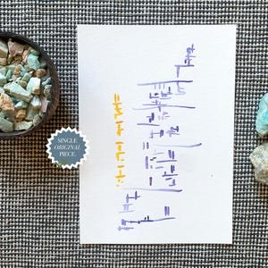 May include: An overhead shot features a wooden bowl filled with turquoise and tan stones, a white paper with purple and yellow markings, and two loose stones. A sticker reads "SINGLE ORIGINAL PIECE". The background is a black and white checkered pattern.