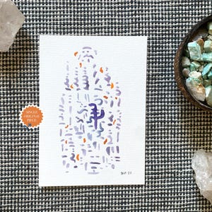 Op de afbeelding: Een aquarelverfschilderij op wit papier met abstracte vormen in paars en oranje. Het schilderij is gesigneerd en gedateerd. Een sticker leest "Single Original Piece". Het schilderij wordt tentoongesteld met kristallen en een kom met stenen.