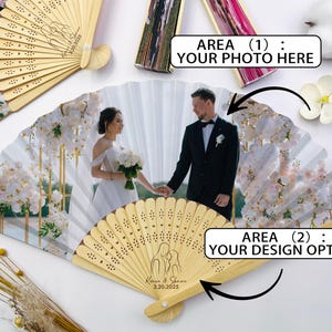 May include: Wooden hand fans with a personalized photo and design. The fans feature a photo of a couple, with the text "Karen & Shuan 3.20.2025" on the handle. The fans are a light tan color and are decorated with a floral design.