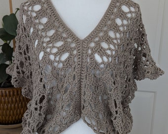 May include: A crocheted top with a V-neck and short sleeves. The top is made of a light brown yarn and has a delicate, openwork design.