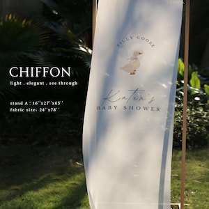 May include: A sheer white chiffon fabric banner hanging on a wooden frame. The banner features a graphic of a goose with a blue bow and the text "SILLY GOOSE" and "Katen's BABY SHOWER". The stand measures 16"x27"x65" and the fabric is 24"x78".