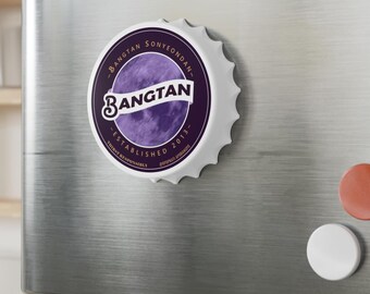 May include: A circular bottle cap magnet featuring a purple tie-dye background with a white banner across the center. The text reads Bangtan, Bangtan Sonyeondan, Established 2013, and Thirst Responsibly in dark purple and white lettering.