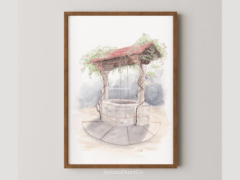 May include: Watercolor print of a wishing well with a red roof and climbing vines. The well is made of stone and has a circular base. The print is framed in a brown wooden frame. The text "SistersPrintCo" is visible at the bottom.