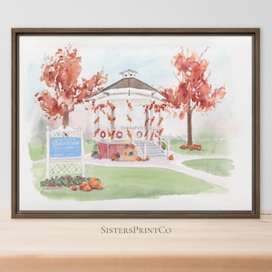 May include: A watercolor print in a brown frame depicting a white gazebo surrounded by autumn trees with orange foliage. A blue sign stands in the foreground near pumpkins and flowers. The text SistersPrintCo is printed below the artwork.