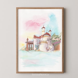 May include: A watercolour print of a castle with red roofs and white towers, set against a backdrop of pink and blue hues. The artwork is framed in a wooden frame and features the text "SistersPrintCo" at the bottom.