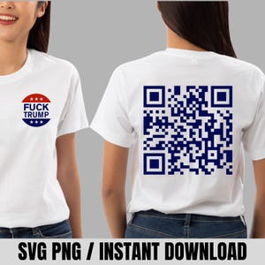 May include: White t-shirt with the text "FUCK TRUMP" in a red, white, and blue design on the front. The back of the shirt features a large blue QR code. The shirt is a casual style.