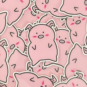 May include: A pile of pink pig stickers with black outlines and blush marks on their cheeks. The pigs have small, curled tails and are in various poses.