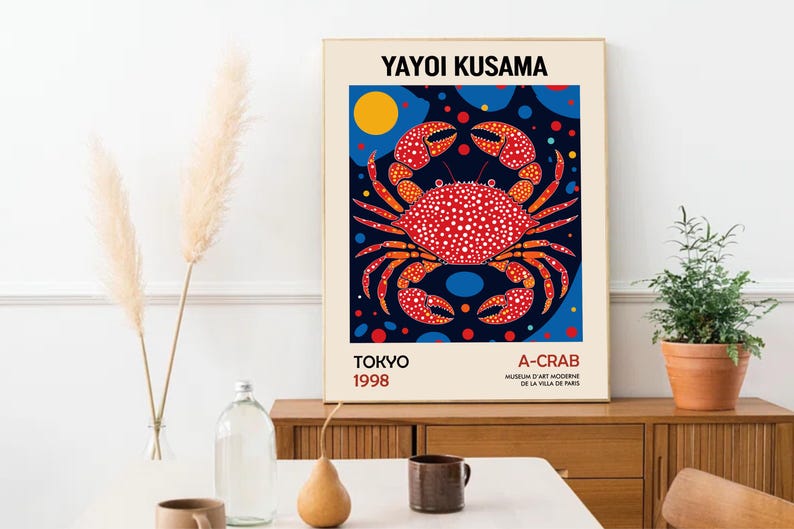 May include: A poster featuring a red and white crab with polka dots on a blue background with yellow and blue circles. The poster is titled "Yayoi Kusama" and includes the text "A-Crab" and "Tokyo 1998".