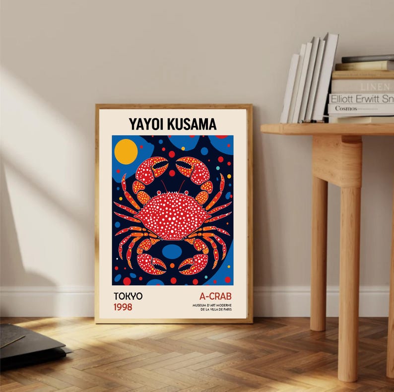 May include: A poster featuring a red and orange crab with white polka dots on a blue background with yellow, red, and blue circles. The poster has the text "YAYOI KUSAMA" at the top, "TOKYO 1998" at the bottom left, and "A-CRAB MUSEUM D'ART MODERNE DE LA VILLA DE PARIS" at the bottom right.