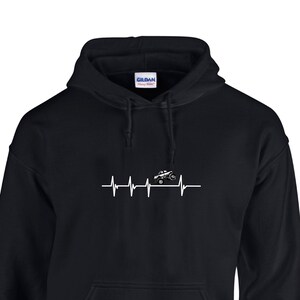 May include: Black hooded sweatshirt with a white graphic of a monster truck with a heartbeat line.