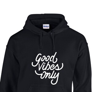 May include: Black hooded sweatshirt with white text that reads "Good Vibes Only".