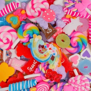 May include: Assortment of colorful candy charms, including lollipops, gumdrops, and candy canes. The charms are made of resin and have a glossy finish.