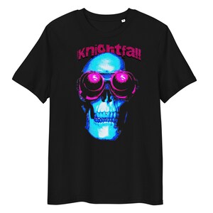 May include: Black t-shirt featuring a blue skull wearing pink goggles and the text "Knightfall" in pink.