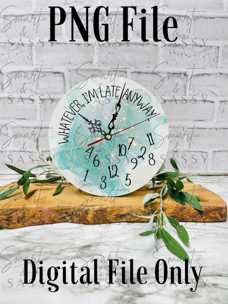 May include: A teal and gold clock with a white background and the text "Whatever, I'm Late Anyway". The clock is on a wooden surface.