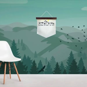 May include: A white canvas banner with a black mountain silhouette and the text "I'd Rather Be Under The Stars" hanging on a wooden dowel rod against a green and blue mountain landscape with a flock of birds flying overhead.