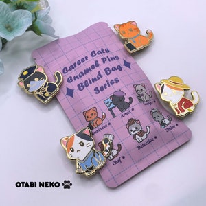 May include: A set of 10 enamel pins featuring cartoon cats in different professions. The pins are gold-toned and have a pink background with a grid pattern. The text on the bag reads "Career Cats Enamel Pins Blind Bag Series".