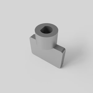 May include: A light grey, 3D-rendered object with a cylindrical top and a rectangular base. The top has a circular hole. The object is set against a plain, light grey background. The design is simple and modern.